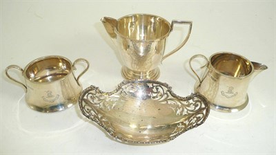 Lot 295 - A silver milk jug, engraved silver sugar basin and cream jug and a silver bon bon dish