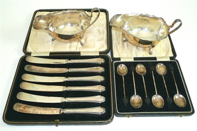 Lot 298 - A pair of silver sauce boats, a case of silver coffee bean spoons and silver handled knives