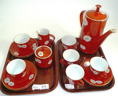 Lot 315 - A Noritake porcelain coffee service, the tomato red ground painted with daisies (rare red mark,...