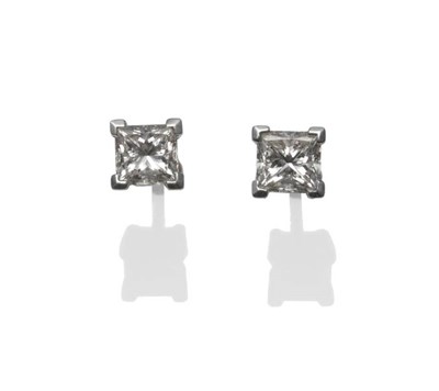 Lot 298 - A Pair of Princess Cut Diamond Solitaire Stud Earrings, the princess cut diamonds in a white...