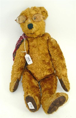 Lot 369 - A Continental teddy bear with gold mercerised cotton fur and a pair of spectacles