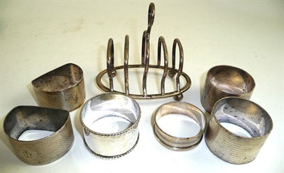 Lot 388 - Silver napkin rings and a silver toast rack