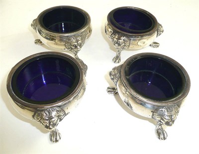 Lot 401 - A set of four Georgian silver salts with blue glass liners