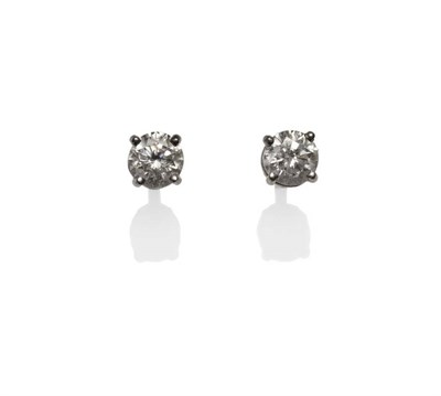 Lot 306 - A Pair of Diamond Solitaire Stud Earrings, the round brilliant cut diamonds held in white four claw