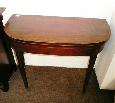 Lot 511 - George III mahogany fold over card table