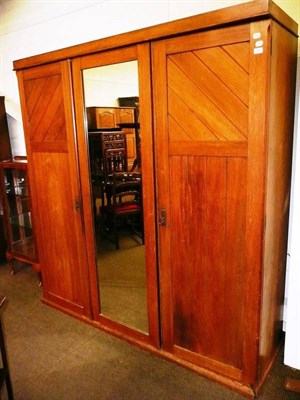 Lot 515 - A walnut triple door wardrobe with brass plaque 'T.Simpson & Son Steam Cabinet Makers, Halifax'