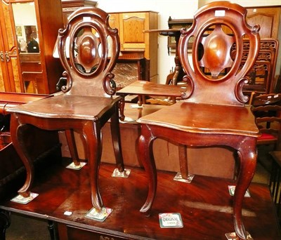 Lot 542 - A pair of Victorian mahogany hall chairs