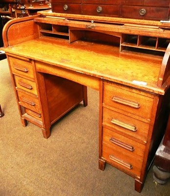 Lot 545 - An early 20th century oak roll top desk