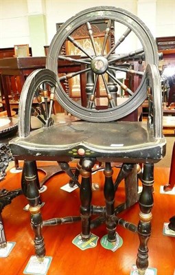 Lot 562 - An ebonised spinning wheel chair