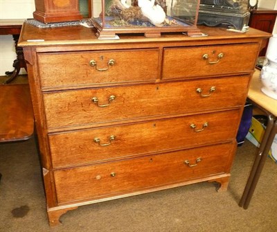 Lot 570 - A Georgian oak straight fronted chest with canted stiles