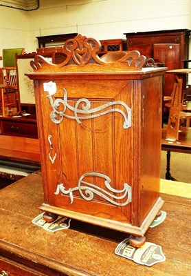 Lot 597 - An Arts & Crafts oak cabinet