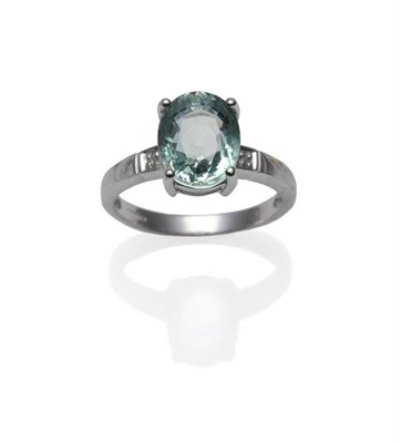 Lot 323 - An 18 Carat White Gold Tourmaline and Diamond Ring, the oval mixed cut tourmaline in a white...