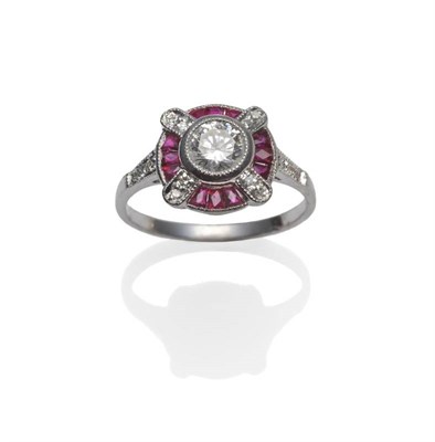 Lot 331 - A Diamond and Ruby Cluster Ring, a round brilliant cut diamond within a border set with...