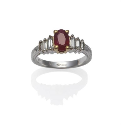 Lot 332 - A Platinum Ruby and Diamond Ring, the oval mixed cut ruby in yellow claw settings, flanked by...