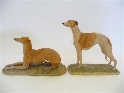 Lot 1025 - Two Border Fine Arts Dogs 'Greyhound' lying, model No. 064A by David Geenty, tan colour, 11.9cm...