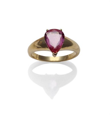 Lot 338 - An 18 Carat Gold Pink Sapphire Ring, the pear cut pinky-orange coloured sapphire in a yellow...