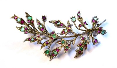 Lot 339 - A Floral Spray Brooch, inset with eight-cut diamonds, various emeralds and rubies, in white...