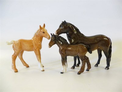 Lot 1146 - Beswick Exmoor Pony 'Heatherman', model No. 1645, bay gloss, 16.5cm high; Palomino Shire Foal,...