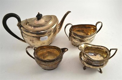 Lot 14 - A three piece silver tea service and a silver cream jug