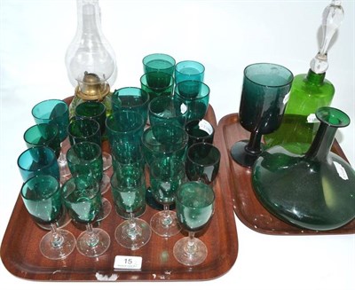 Lot 15 - A quantity of green glass, including decanter, bell and oil lamp (on two trays)