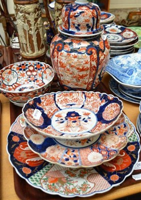 Lot 26 - Three Imari dishes, a plate, bowl and stand and a vase and cover (a.f.)