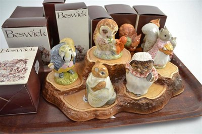 Lot 38 - Eight Beswick Beatrix Potter figures and a pottery 'tree stump' display stand (with boxes)