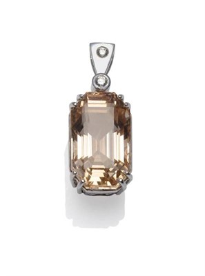 Lot 357 - A Topaz and Diamond Pendant, the emerald-cut peach coloured topaz in a white double claw...