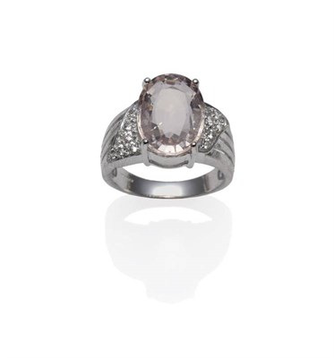 Lot 358 - An 18 Carat White Gold Morganite Ring, the oval mixed cut morganite with white topaz on the...