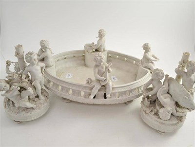 Lot 137 - Biscuit porcelain centrepiece with children playing musical instruments and a pair of similar...