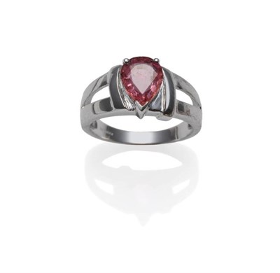 Lot 367 - An 18 Carat White Gold Padparadscha Ring, the pear cut sapphire in a claw setting, to chunky...