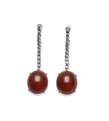 Lot 368 - A Pair of Garnet and Diamond Drop Earrings, a row of round brilliant cut diamonds suspends a...