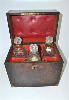 Lot 169 - A 19th century amboyna decanter box with three decanters and liqueur tots to the base drawer
