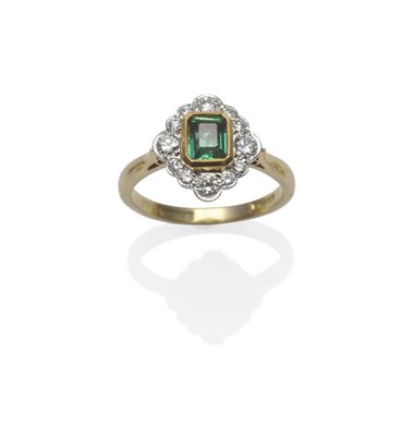 Lot 371 - An 18 Carat Gold Emerald and Diamond Cluster Ring, the emerald-cut emerald in a yellow...