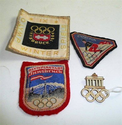 Lot 220 - A 1936 Berlin Olympics Enamel badge and three fabric Olympic badges