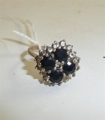 Lot 233 - A sapphire and diamond cluster ring