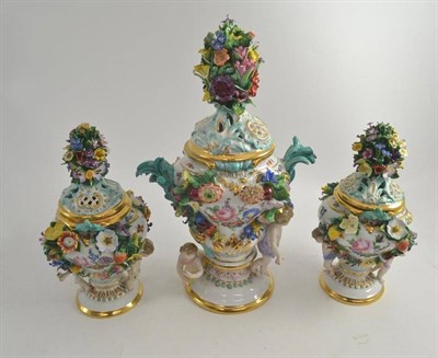 Lot 250 - A Dresden flower encrusted porcelain garniture of three vases and covers (a.f.)