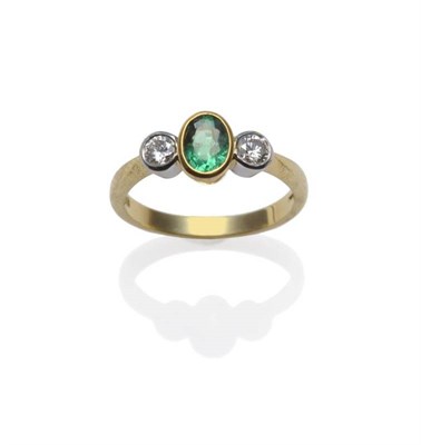 Lot 378 - An 18 Carat Gold Emerald and Diamond Three Stone Ring, the oval mixed cut emerald flanked by a...