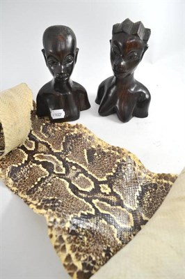 Lot 253 - Python snake skin and two African carved busts