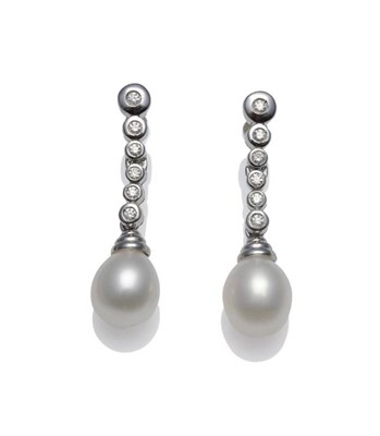 Lot 381 - A Pair of Diamond and Cultured Pearl Drop Earrings, a row of round brilliant cut diamonds in...