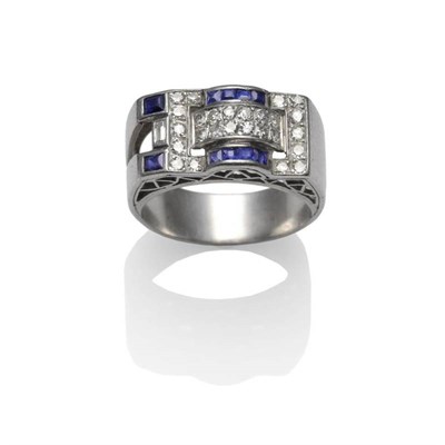 Lot 382 - A Sapphire and Diamond Cocktail Ring, the Art Deco style shape inset with a baguette cut and...