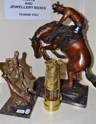 Lot 301 - Two bronzed figures after Remmington on horses and a protector lamp