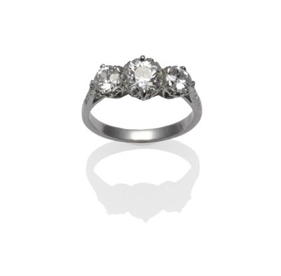 Lot 387 - An Early 20th Century Diamond Three Stone Ring, the graduated old cut diamonds in white claw...