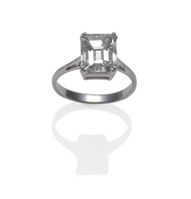 Lot 388 - A Diamond Solitaire Ring, the emerald-cut diamond in a white double claw setting, to a tapered...