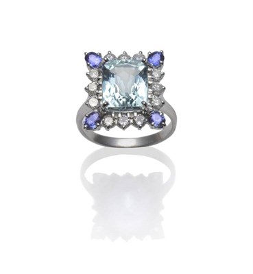 Lot 392 - An 18 Carat White Gold Aquamarine, Tanzanite and Diamond Cluster Ring, the scissor cut...