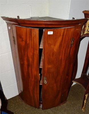 Lot 408 - George III mahogany bow-fronted corner cupboard