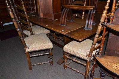 Lot 412 - An oak draw-leaf refectory table and six ladder back chairs