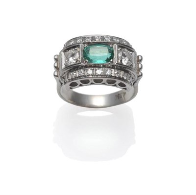 Lot 394 - An Art Deco Style Emerald and Diamond Ring, an oval mixed cut emerald flanked by a round...