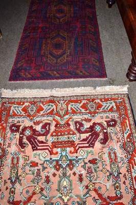 Lot 427 - A Persian apricot ground rug and two other rugs (3)