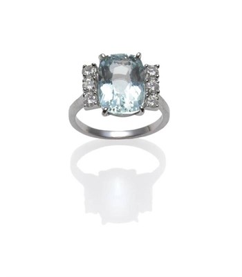 Lot 395 - An 18 Carat White Gold Aquamarine and Diamond Ring, the cushion shaped aquamarine flanked by...