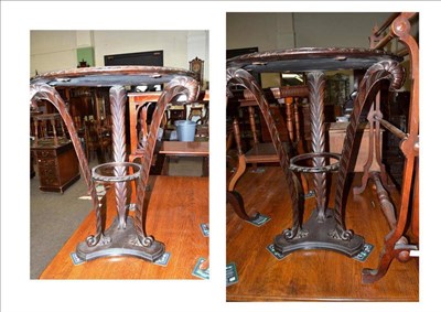 Lot 433 - A pair of mahogany circular tables inset with red leather on carved supports